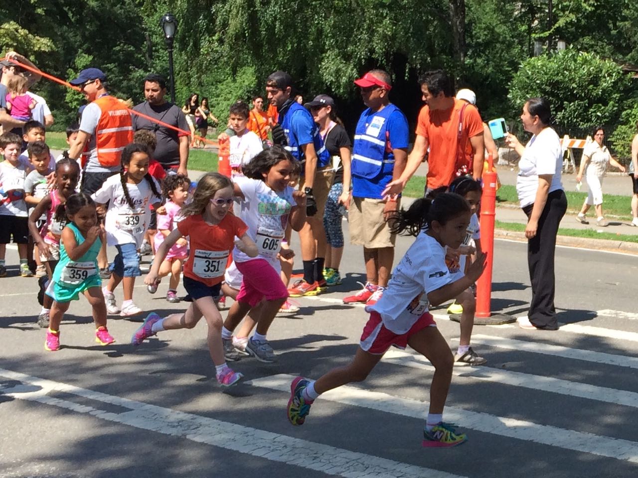 Young girls run at the Achilles Hope and Possibility 2014 race events in New York Central Park.