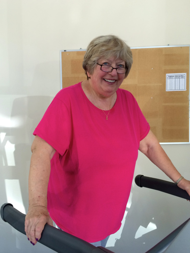Senior client on treadmill who no longer needs walker or cane.